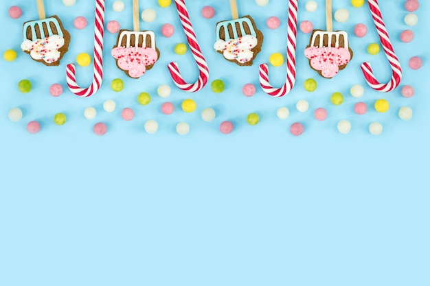 Sweets candies cookies and lollipops on a blue background Sweet Christmas Canes Top view copy space