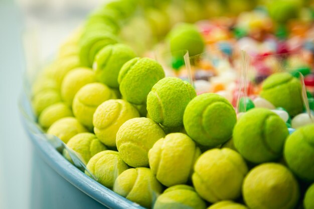 Sweets and candies in the form of tennis balls close up in a shop