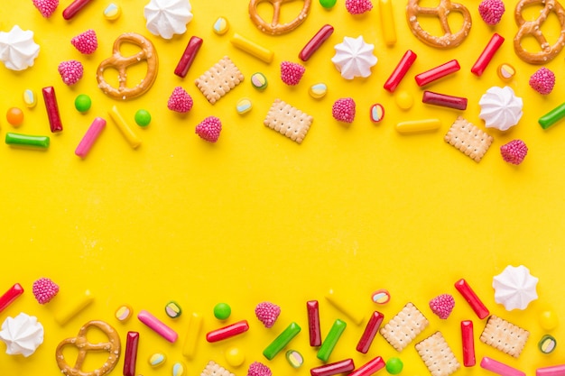 Sweets flat lay on yellow background