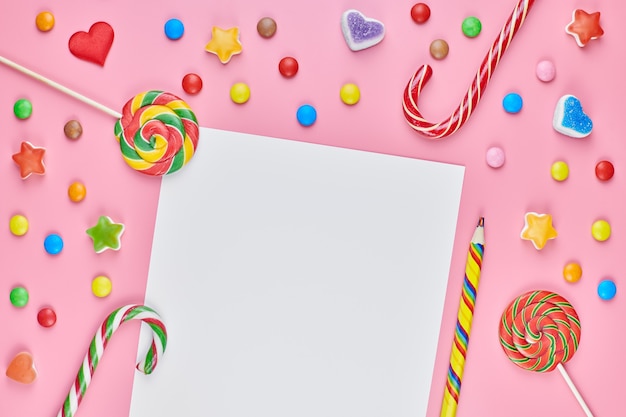 Sweets, lollipops and candy canes with paper