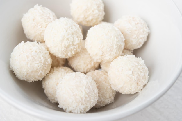 Sweets with almonds and coconut in a plate closeup