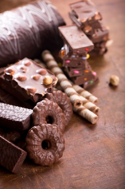 Сладости с орехами и шоколадными пряниками и шоколадом на деревянном фоне