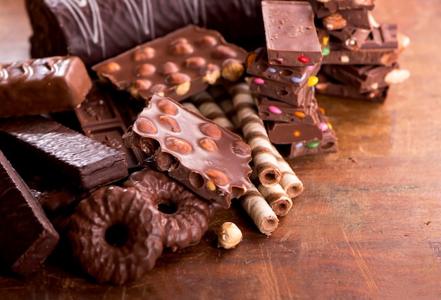 Sweets with nuts and chocolate gingerbread cookies and chocolate on a wooden background