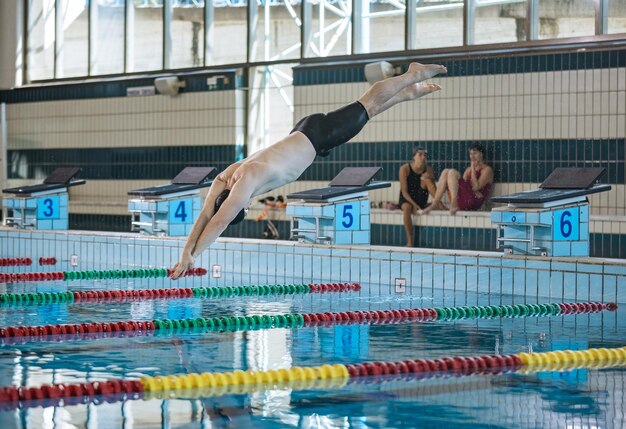 Swimmer jumping off the starting block