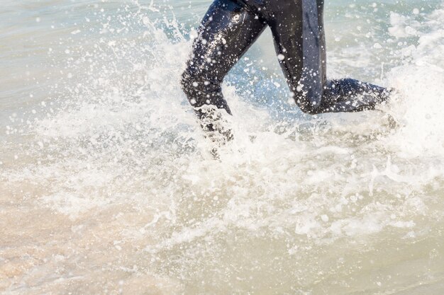 Swimmer running in the ocean