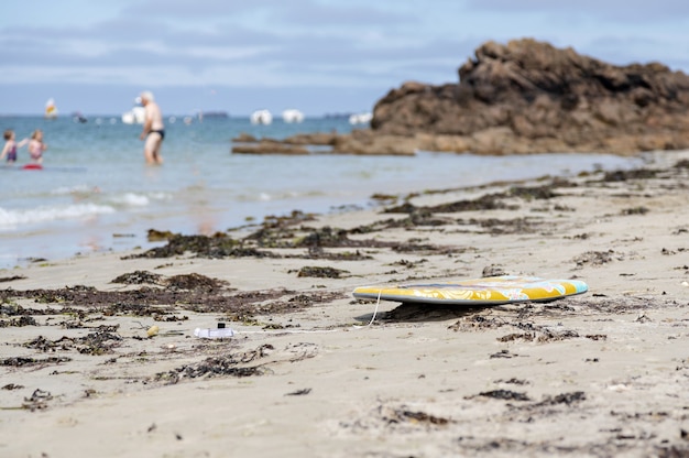 Swimming board laid on the sand