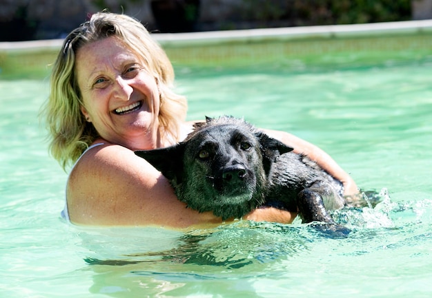 Swimming Dutch Shepherd and woman