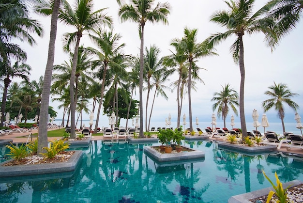 Swimming pool beside the sea with coconut tree modern luxury hotel, Samui island, Thailand