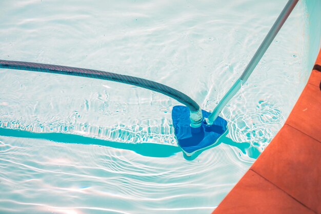 Swimming pool cleaning tools in the bottom of the pool. clear\
water in the pool.