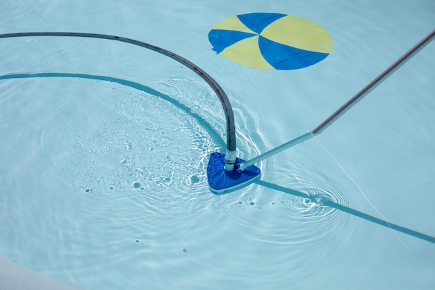 Swimming pool cleaning tools in the bottom of the pool. clear
water in the pool.