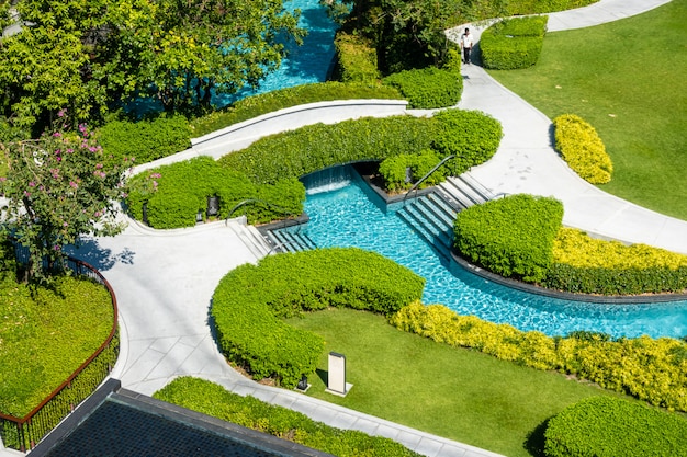 swimming pool in garden decoration in hotel resort