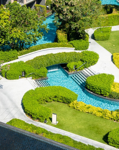 swimming pool in garden decoration in hotel resort