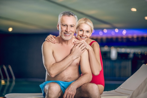 In the swimming pool. Happy couple spending time in a swimming pool