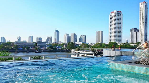 Swimming pool in hotel against cityscape