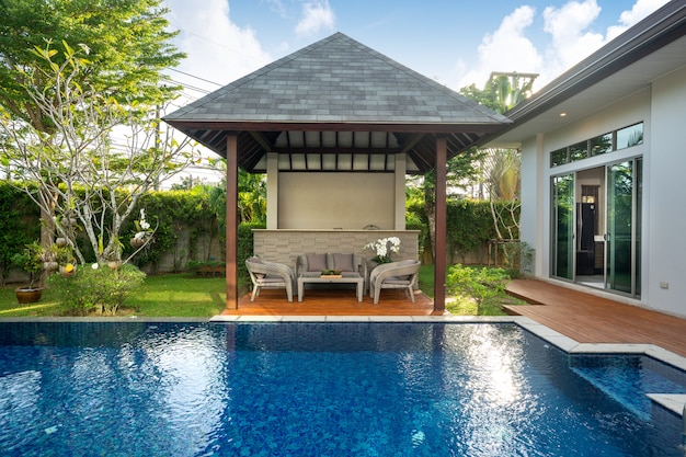 Swimming pool and pavilion with green garden