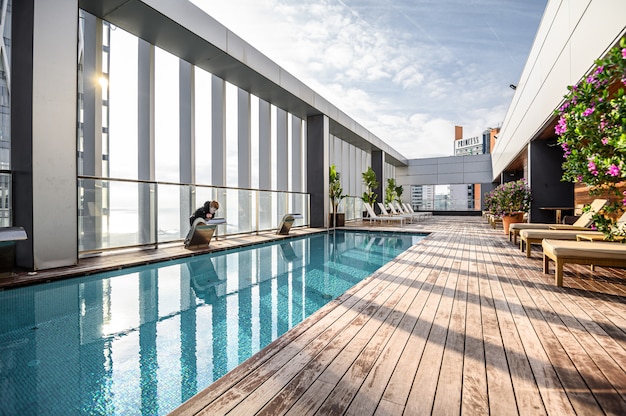 Swimming pool on roof top with beautiful city view of the skyscrapers. . Premium hotel. 03.01.2020 Barcelona, Spain