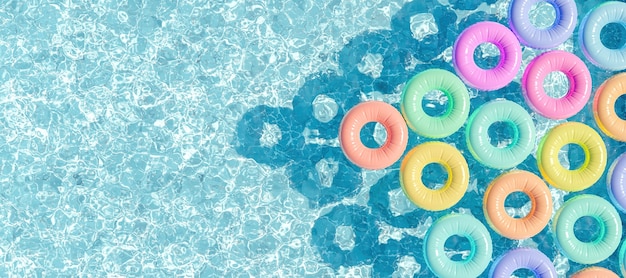 Photo swimming pool seen from above with many rings floating in pastel colors