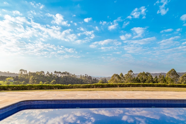 Swimming pool with blue sky and forest