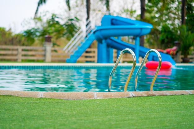 swimming pool with blur of water slide background