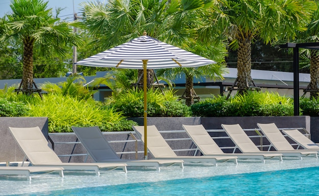 Swimming pool with chaise loungers