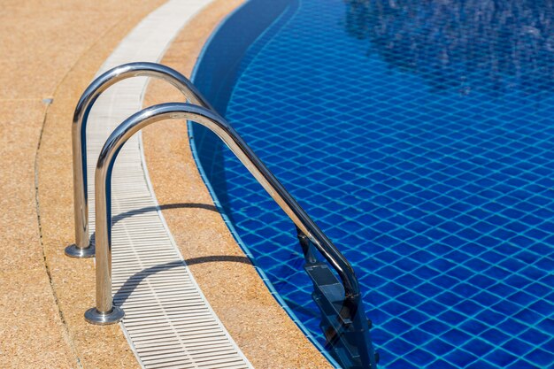 swimming pool with pool ladder in hotel