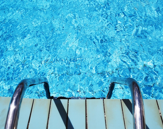 Swimming pool with stair at hotel close up