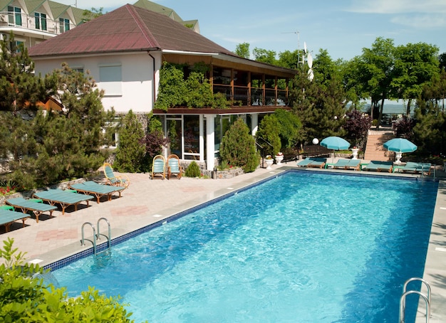 Swimming pool with tables for leisure travelers at the hotel