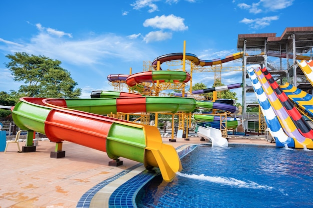 Swimming pool with water slides in aqua park on sunny day summer fun activity vacation leisure concept