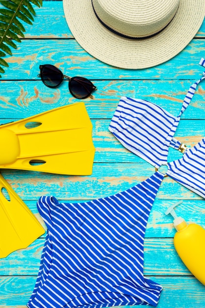 swimsuit on color wooden background