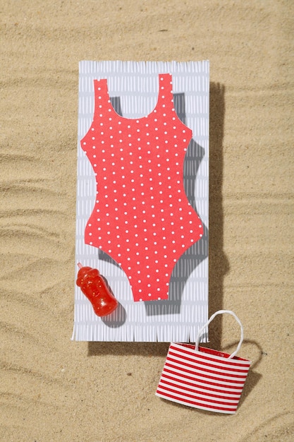 swimsuit with fruits on the sand recreation concept