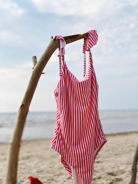 Swimsute hanging on beach against sky