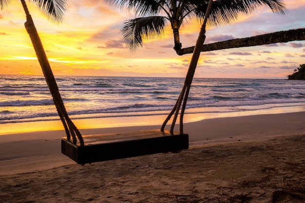 Swing on beach with sunset.