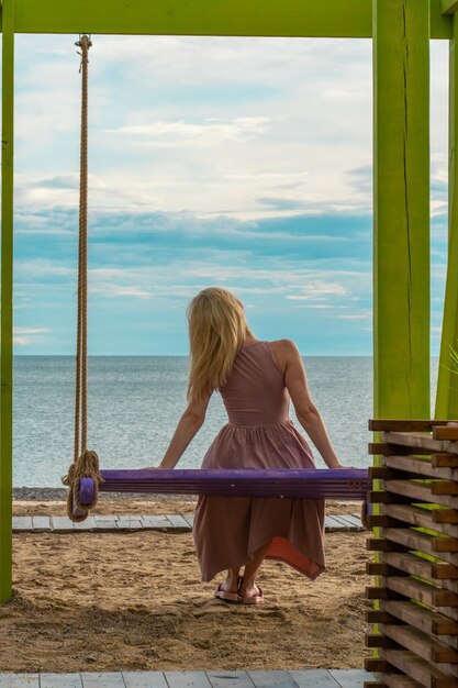 Swing happy sea summer travel beach woman leisure beautiful tourist from dream Young calm landscape