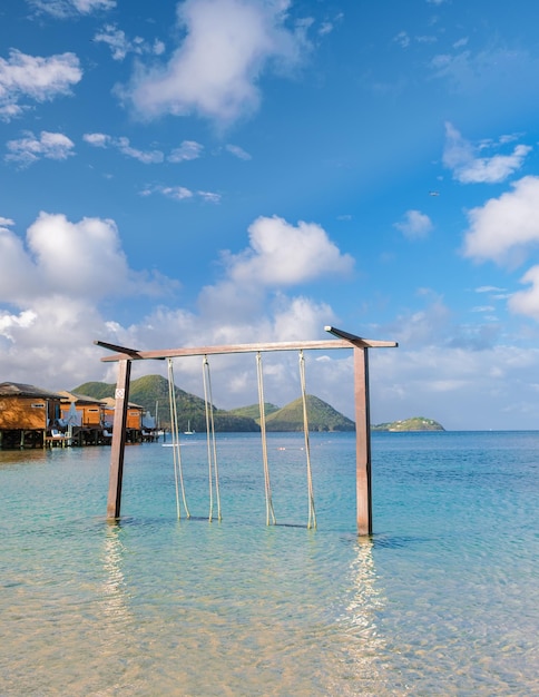 Swing in the ocean on the beach of the tropical island saint\
lucia or st lucia caribbean