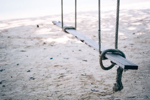 Swings or wooden hanging on the rope by the sea.