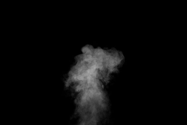 Swirling wriggling smoke steam isolated on a black background for overlaying on your photos Fragment of vertical steam Abstract smoky background design element