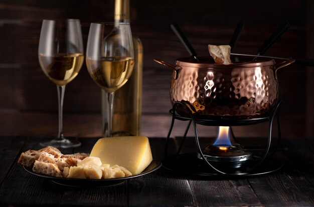 Swiss  cheese fondue on rustic background