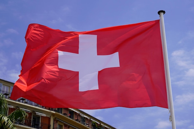 Swiss flag italian floating in mat with wind in cloud sky