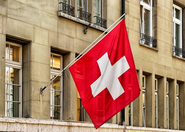 Swiss flag waving in the street at the old city center of Bern, Switzerland