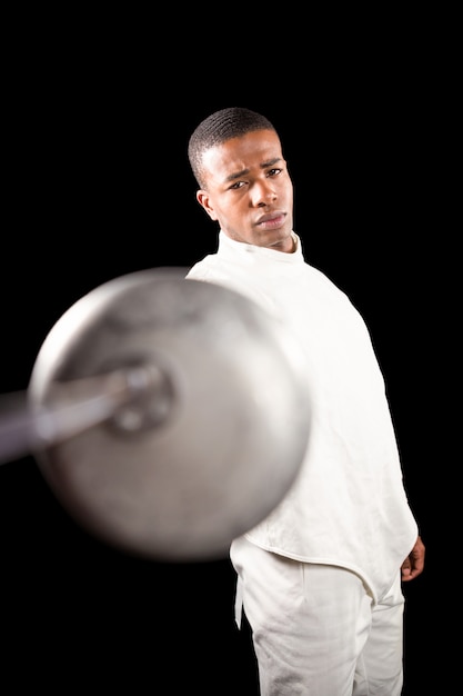 Swordsman practicing with fencing sword