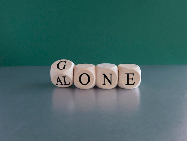 Symbol for alone and gone Turned a dice and changes the word gone to alone green background