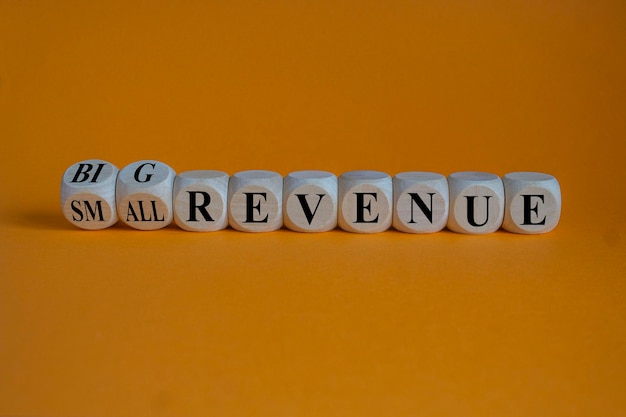 Symbol for a better revenue turned wooden cubes and changes words small revenue to big revenue