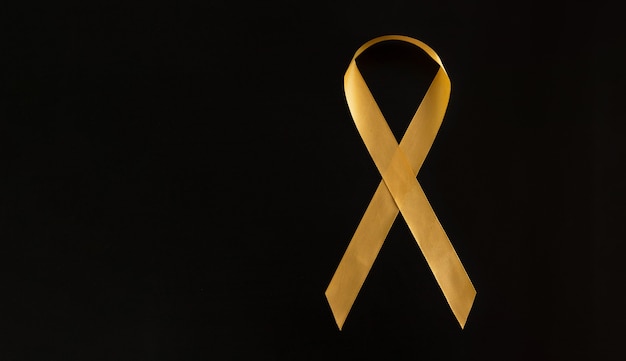 a symbol of the fight against childhood cancer. go baby cancer gold. space for text