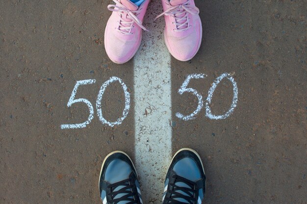 Symbol of gender equality 50/50 on asphalt, gender concept