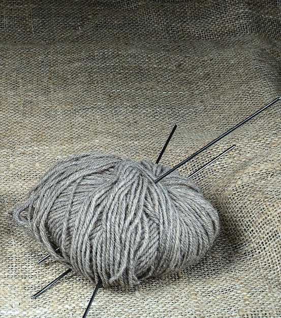 A symbol of home comfort a ball of woolen threads for knitting on a background of burlap