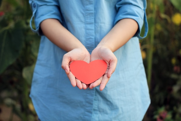 Symbol of love on the palm of a woman