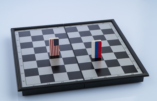 Symbols flag of Russia and the United States on the chessboard. The concept of political game.