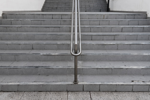 Symmetrical ladder stairway with hand railing on the middle