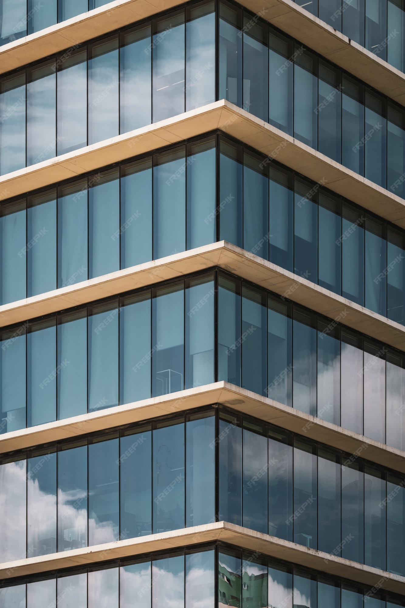 Premium Photo | Symmetrical view of the corner of an office building with  vertical glazed windows