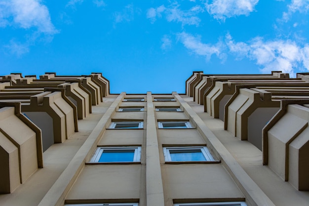 Symmetry of balconies and windows against the blue sky